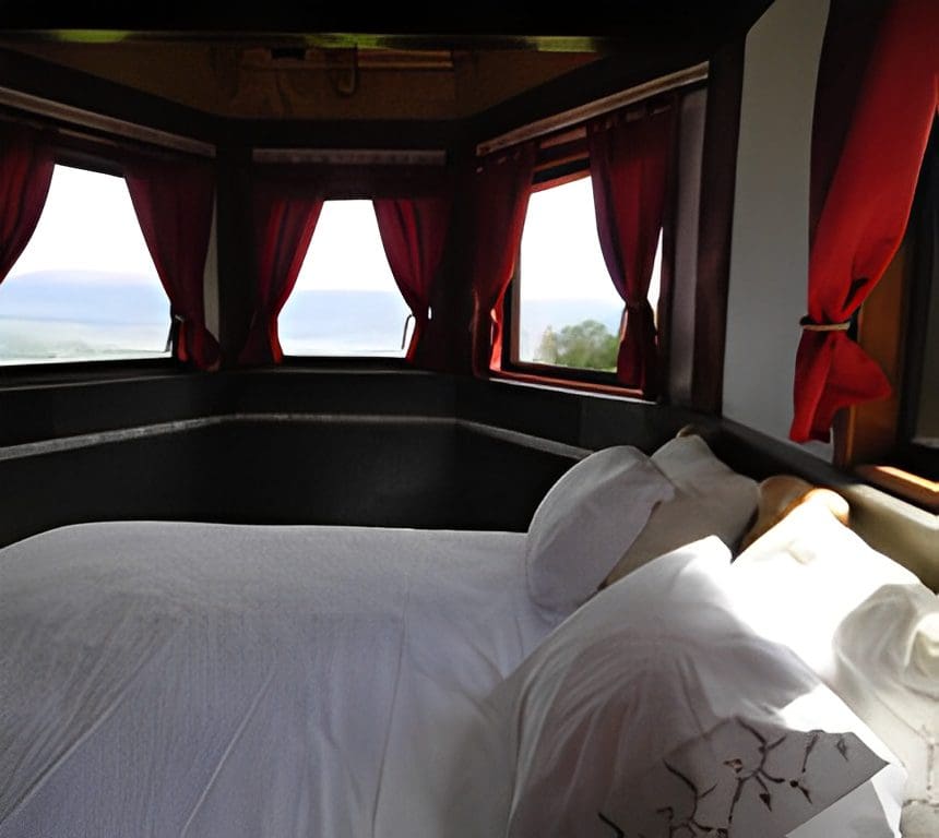 Cozy bedroom with ocean view windows.