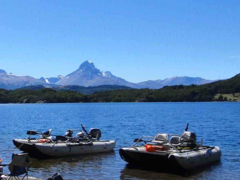 Boats on lake with mountain background.