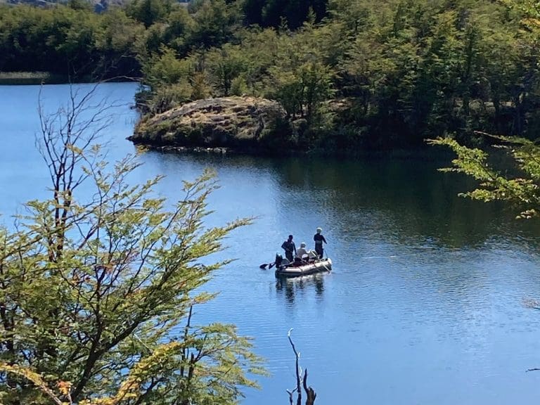 People fishing on a small inflatable boat.