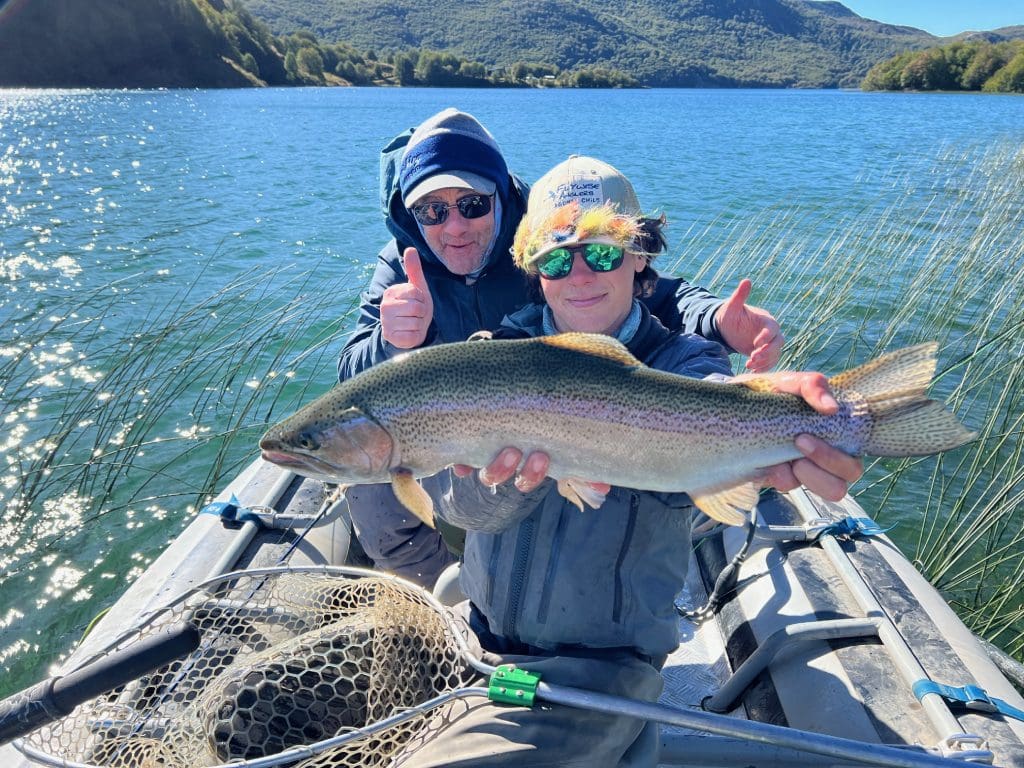 Two people holding a large fish, smiling.