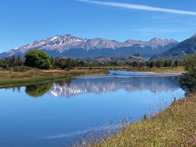 Mountain landscape with river and clear sky.